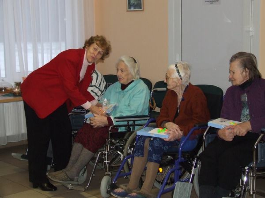 SVEICIENS SVĒTKOS! Pensionāru biedrības pārstāve Rasma Kazimirova sveic skrīverieti Ilgu Krūskopu.