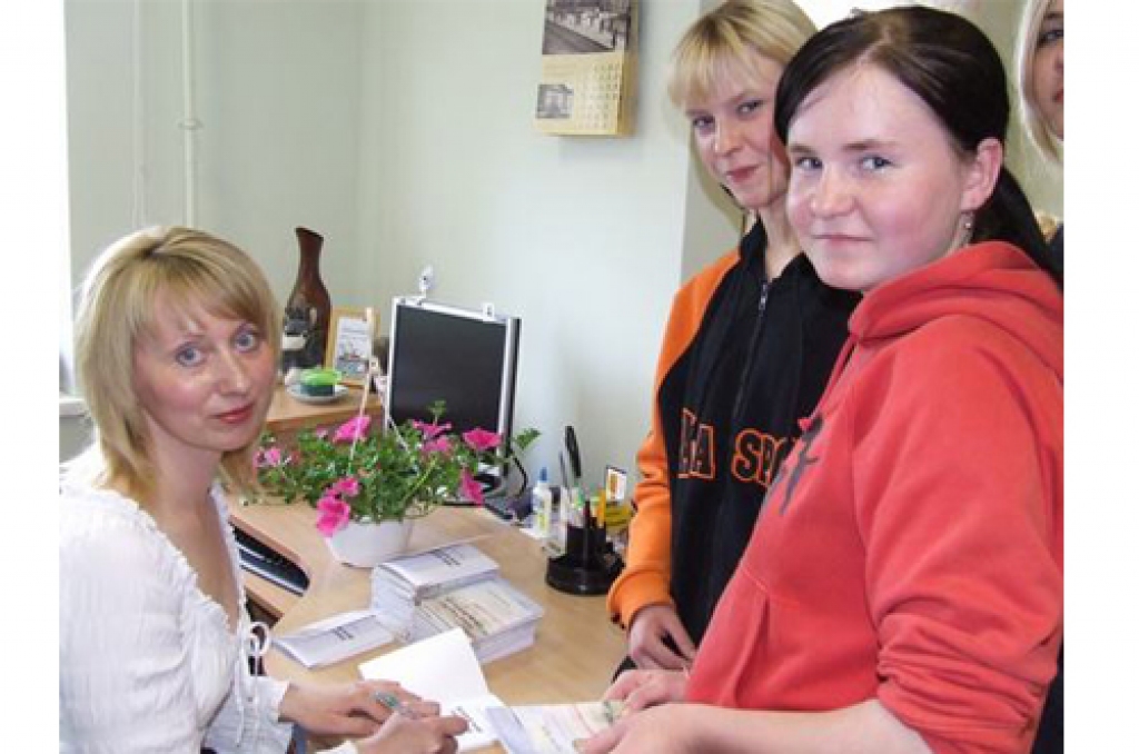 PIRMIE VELTĪJUMI. Dzejniece Sarmīte Rode ieraksta autogrāfus skolniecēm Ligijai (no labās) un Kristīnei.  