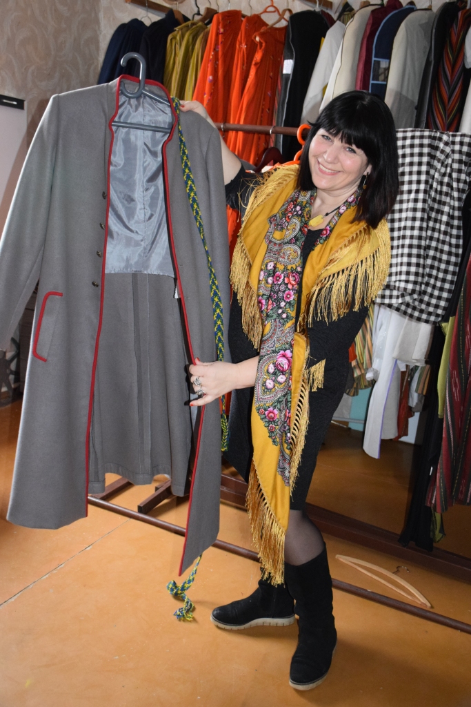 SVĒTKU DALĪBNIECE AR STĀŽU. “Esmu pārliecināta, katram ir jādara savs darbs, lai svētki izdotos,” teic Gunita Krievāne. Attēlā — Gunita demonstrē deju kolektīva “Kodols” dejotāju jaunos mēteļus.