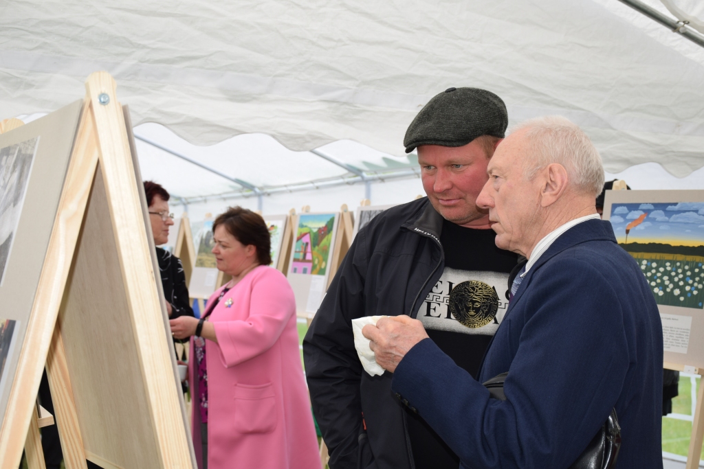 Pļaviņietis Jānis Spārniņš (no labās) izstādes apmeklētājiem stāstīja par savās fotogrāfijās redzamajām vietām un notikumiem — labības kulšanu viņa dzimtas mājās pirms vairāk nekā 70 gadiem, pirmo traktoru sētā un cukurbiešu novākšanas talku Aiviekstes pagastā.
Autors: autores