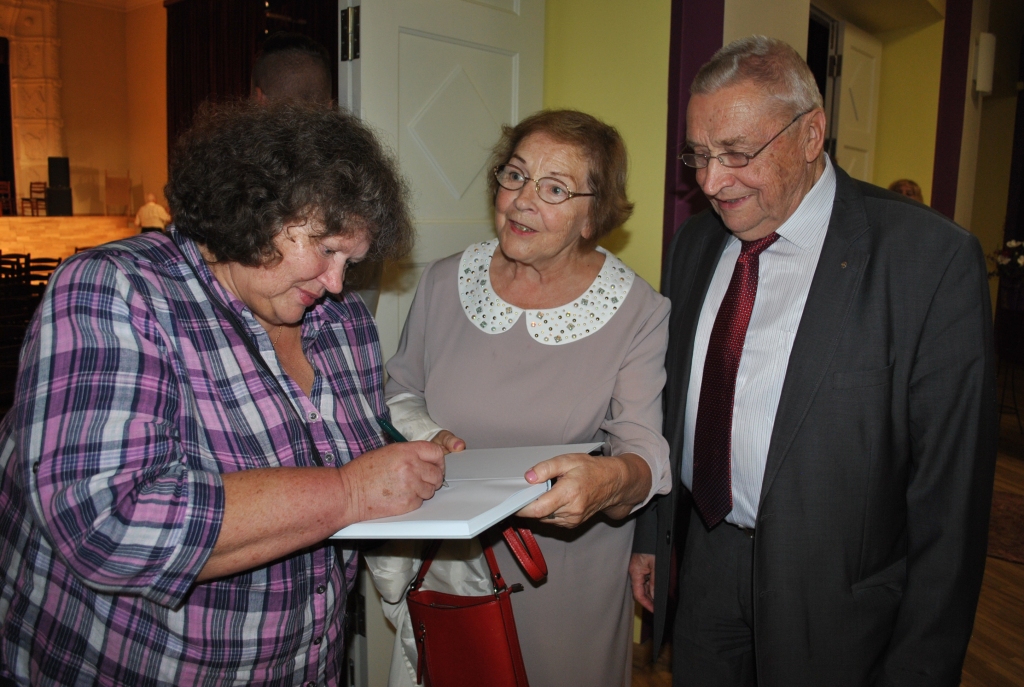 PIEMIŅAI. Ierakstu grāmatā veic Jāņa Zvaigznes meita Inese (no kreisās), kas ir veltījums Zvaigznes bijušai skolniecei Veltai Pētersonei ar dzīvesbiedru.