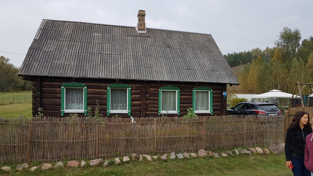 Senatnes elpa — zedeņu žogi un logi ar koka izgriezumiem un slēģiem.