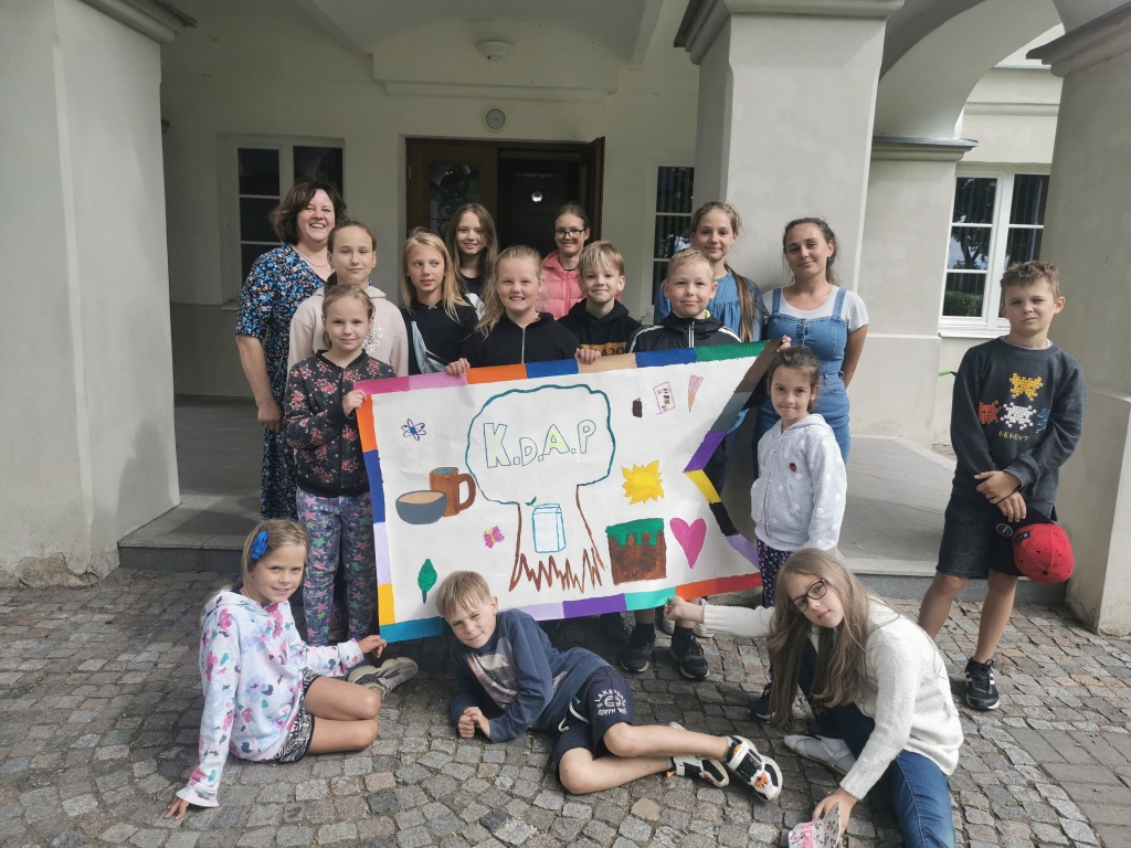 Nometnes noslēgumā bērni fotografējās ar pašu veidoto nometnes karogu.
Autors: no “Ērberģietēm”