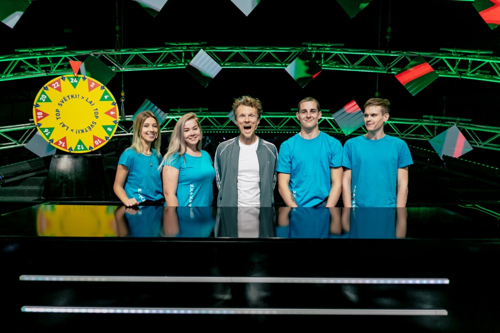 Kamēr Latvijas Skolu jaunatnes dziesmu un deju svētki nevar notikt Mežaparkā un Daugavas stadionā, Latvijas Televīzija sešus sestdienu vakarus piedāvā pavadīt jautrā un muzikālā kompānijā, noskaidrojot, kurš Latvijas novads vislabāk gatavojies svētkiem un ir zinošākais Dziesmu un deju svētku vēstures faktos. Katru nedēļu spēlē “Lai top svētki!” piedalās trīs komandas, kuru sastāvā ir sabiedrībā zināmi ļaudis — mūziķi, aktieri, LTV personības un jaunieši. Atraktīvā veidā dalībnieki atbild uz vēstures jautājumiem, tērpjas tautastērpos, min dziesmas un dejas un griež Saules ratu. Savus jautājumus komandām sagatavojuši visu Latvijas novadu un diasporu kolektīvi. Zinošākā novada intriga atrisināsies pēdējā — sestajā “Lai top svētki!” raidījumā, kad komandu sastāvos piedalīsies svētku virsdiriģenti un deju virsvadītāji. Spēles “Lai top svētki!” norisi vada raidījuma vadītāji Māra Sleja un Dainis Grūbe, bet svētku melodijas skandina muzikālā grupa Katrīnas Dimantas vadībā. Šo sestdien, 23. oktobrī, novadu sacensībā piedalīsies komandas no Rīgas, Sēlijas (Jaunjelgavas kolektīva “Kodoliņš” jaunieši) un Kurzemes, kuru līderi būs grupas “Instrumenti” dalībnieks Jānis Šipkēvics, folkloras kopas “Tarkšķi” dalībniece Katrīna Karele un grupas “Carnival Youth” mūziķis Kristiāns Kosītis.
Autors: Lauris Vīksne